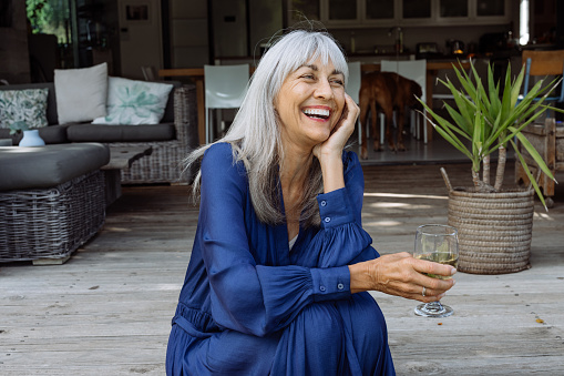 Smiling woman relaxing on her patio.